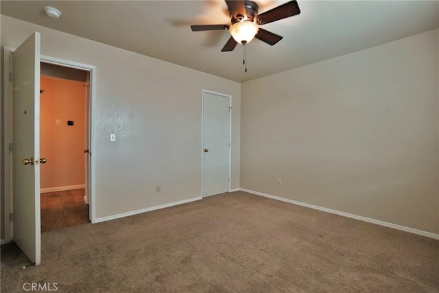 unfurnished bedroom featuring ceiling fan and carpet