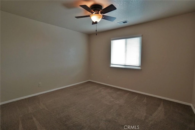 carpeted spare room featuring ceiling fan