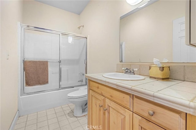 full bathroom featuring enclosed tub / shower combo, vanity, and toilet