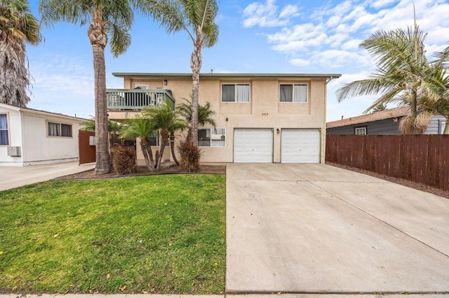 view of front of property featuring stucco siding, concrete driveway, an attached garage, a front yard, and fence