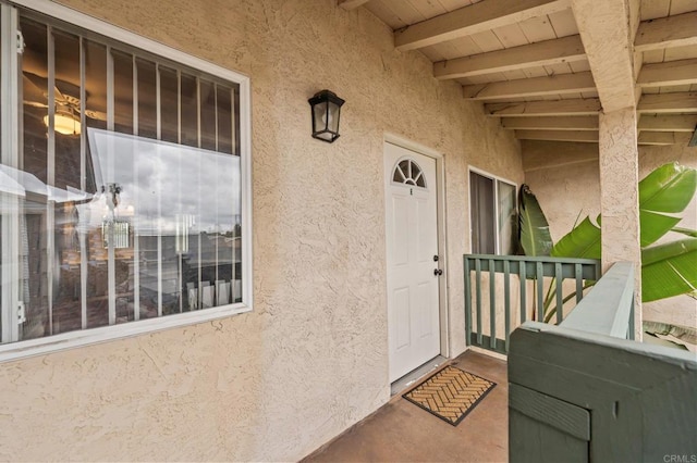 entrance to property featuring stucco siding