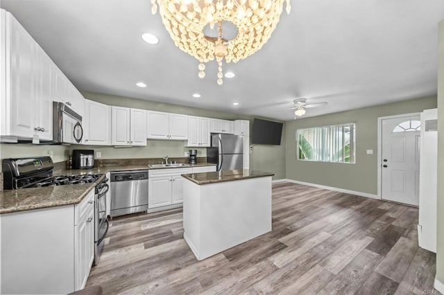 3565 Highland Ave Unit 5, San Diego, CA 92105 - kitchen with stainless steel appliances, a sink, white cabinets, a center island, and recessed lighting