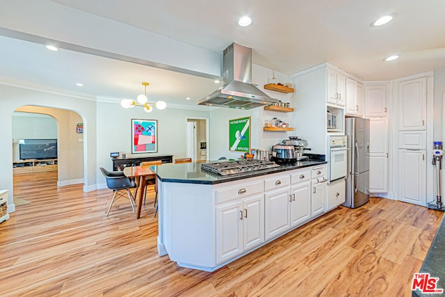 kitchen featuring island range hood, light hardwood / wood-style flooring, white cabinets, and appliances with stainless steel finishes