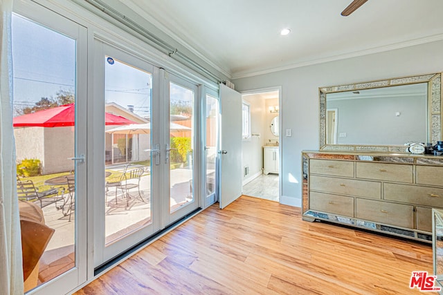 doorway with french doors, crown molding, and light hardwood / wood-style flooring