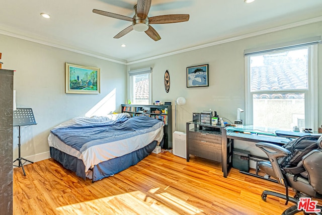 bedroom with crown molding, ceiling fan, and light hardwood / wood-style floors