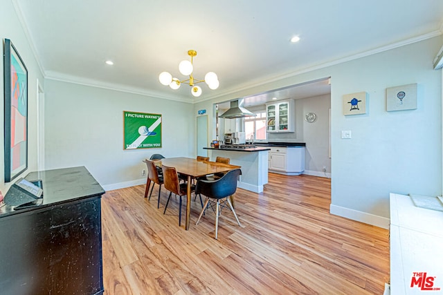 dining room with crown molding, a notable chandelier, and light wood-type flooring