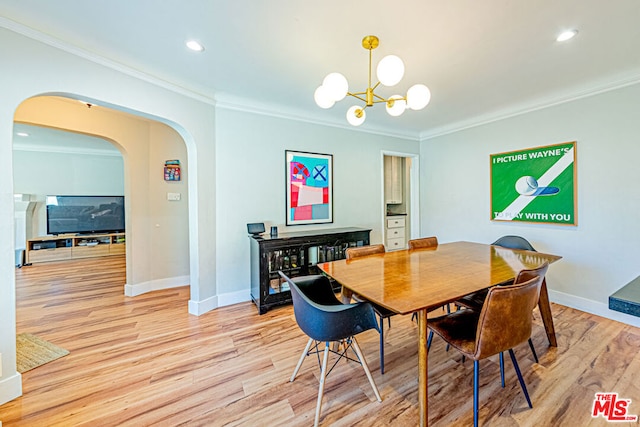 dining room with ornamental molding, a chandelier, and light hardwood / wood-style floors