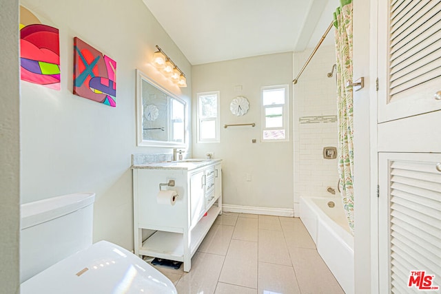 full bathroom featuring tile patterned floors, vanity, toilet, and tiled shower / bath combo