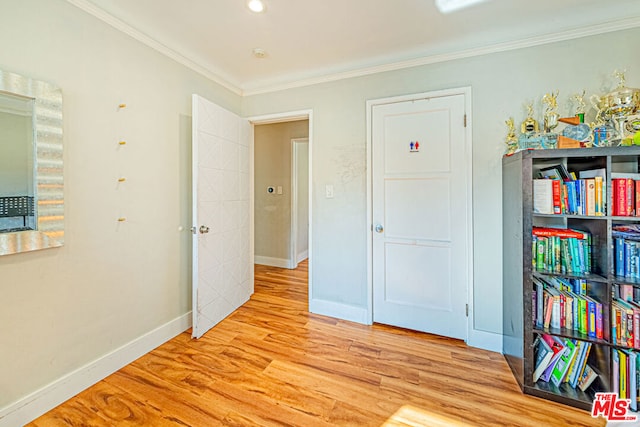 bedroom with ornamental molding and light hardwood / wood-style flooring