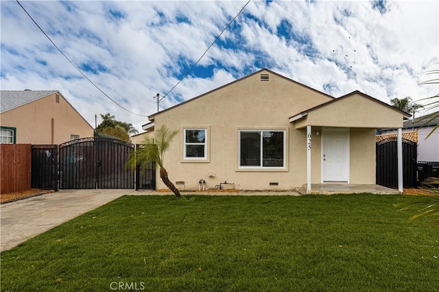 rear view of property featuring a lawn