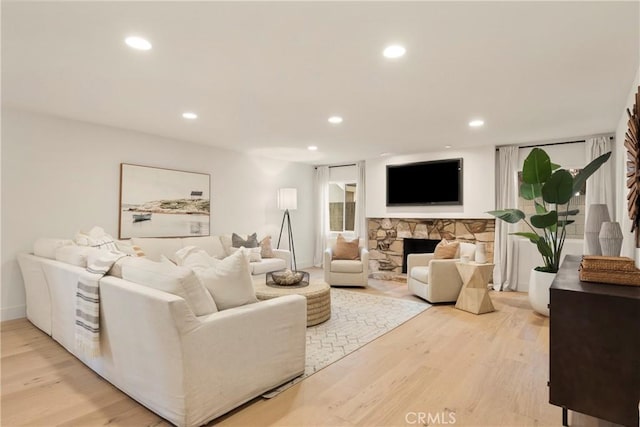 living room with a fireplace and light hardwood / wood-style flooring