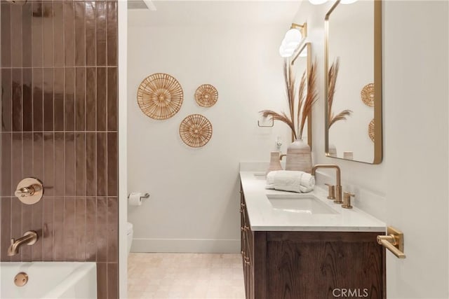 bathroom with vanity, a washtub, and toilet