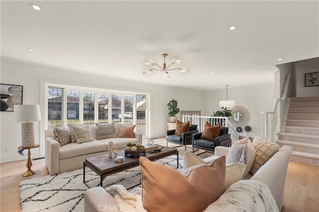 living room featuring an inviting chandelier and light hardwood / wood-style flooring