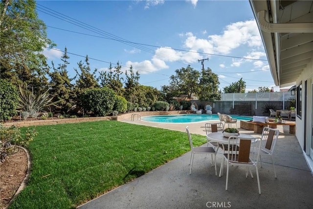 view of pool with a yard and a patio