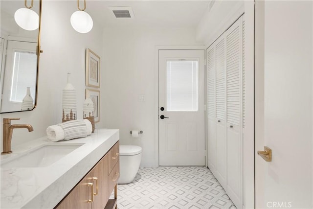 bathroom featuring vanity and toilet