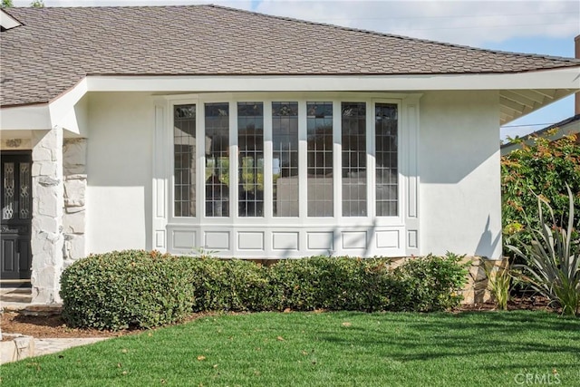 view of side of home with a lawn