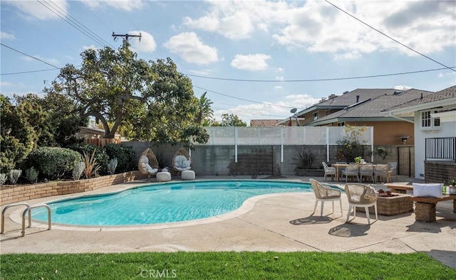 view of swimming pool featuring a patio and an outdoor fire pit