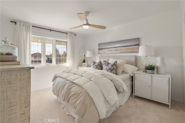 bedroom with ceiling fan and light colored carpet