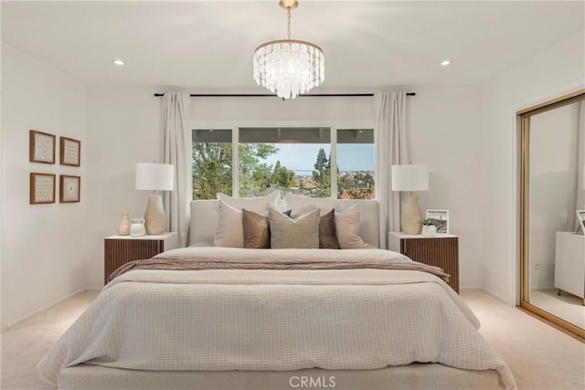 carpeted bedroom with a notable chandelier