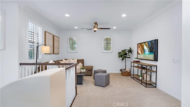 sitting room featuring crown molding, ceiling fan, and light carpet