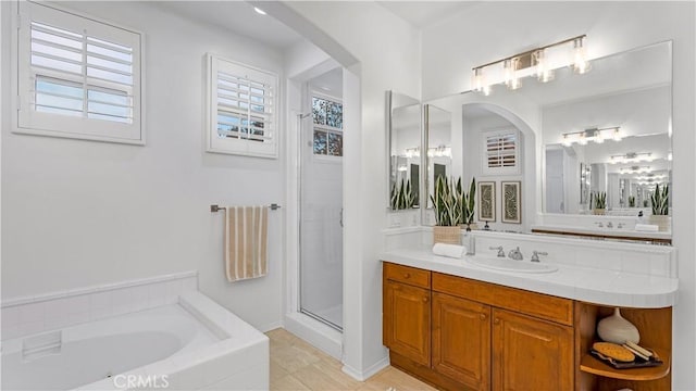 bathroom featuring vanity and plus walk in shower