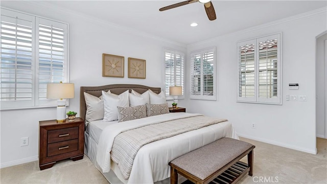 carpeted bedroom featuring crown molding and ceiling fan