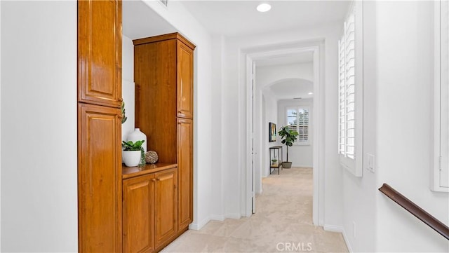 hall featuring light colored carpet