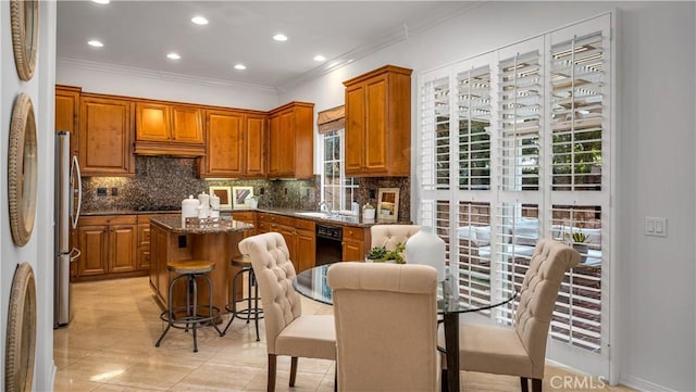 kitchen with a kitchen island, a breakfast bar, dark stone countertops, and decorative backsplash