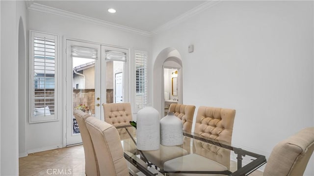 dining room with crown molding, light tile patterned flooring, and french doors