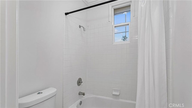 bathroom with shower / tub combo with curtain and toilet