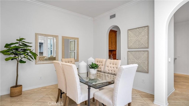 dining room with light tile patterned flooring and ornamental molding