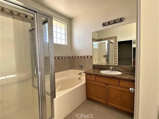 bathroom featuring tile patterned flooring, vanity, and independent shower and bath