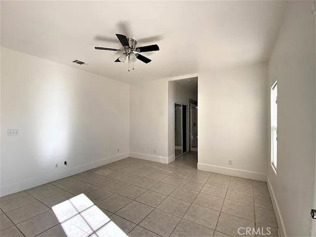 tiled empty room with ceiling fan