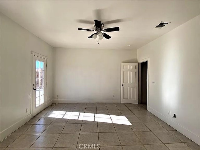 tiled empty room with ceiling fan