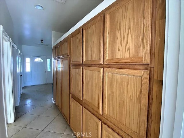 hall featuring light tile patterned floors