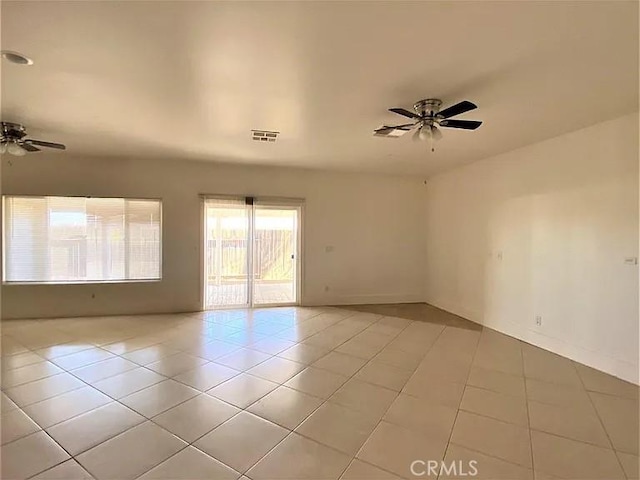 empty room featuring light tile patterned floors and ceiling fan