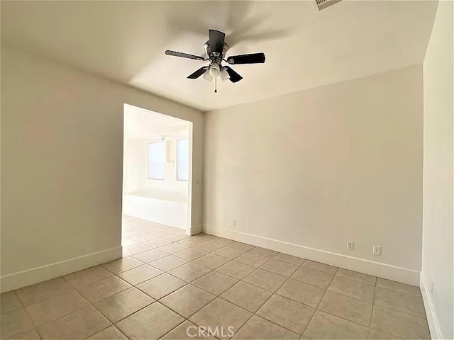 tiled empty room with ceiling fan