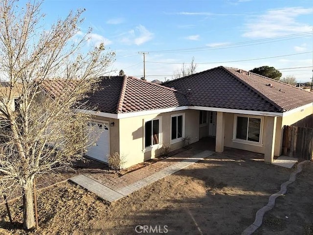 back of property with a garage