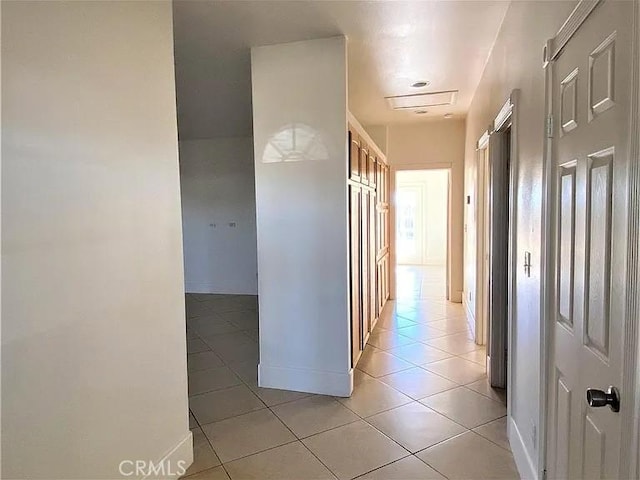 hall with light tile patterned floors