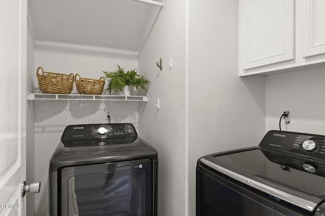 laundry room with cabinets and separate washer and dryer