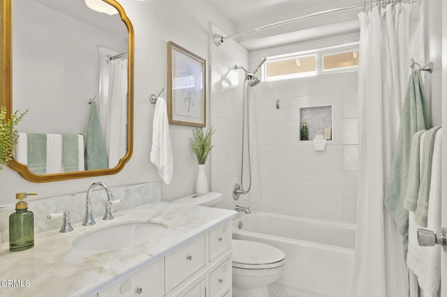 full bathroom with toilet, vanity, and shower / bath combo with shower curtain