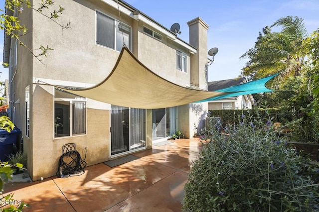 rear view of house with a patio