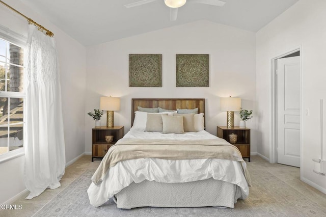 bedroom featuring ceiling fan, lofted ceiling, and light carpet