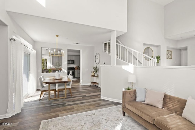 living room featuring dark hardwood / wood-style flooring and a notable chandelier