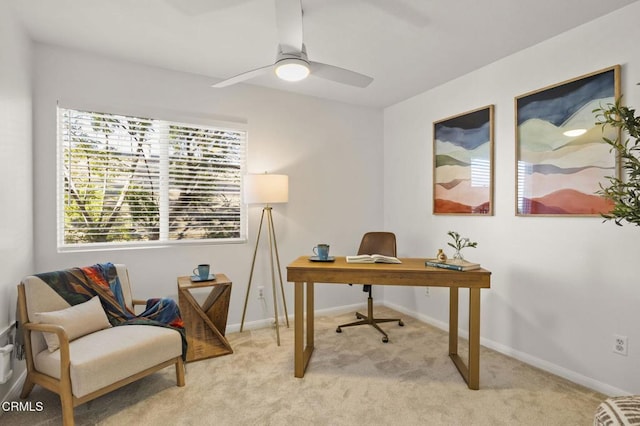 carpeted office space featuring ceiling fan