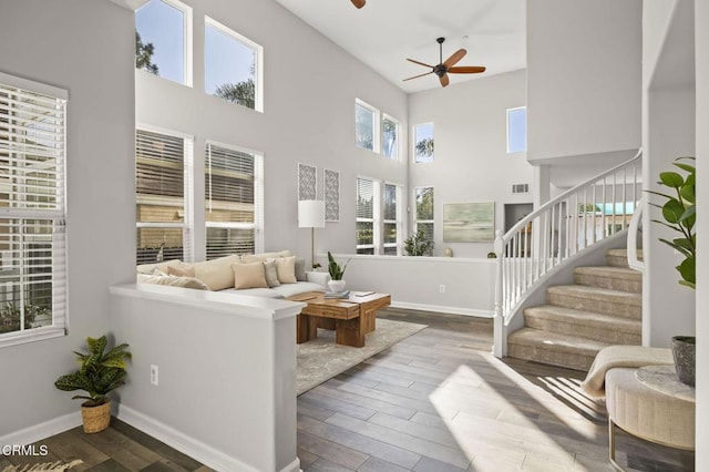 living room featuring hardwood / wood-style flooring and ceiling fan