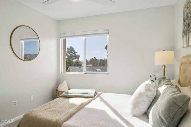 bedroom featuring ceiling fan and carpet