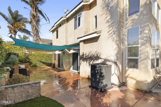 back of house with central AC and a patio