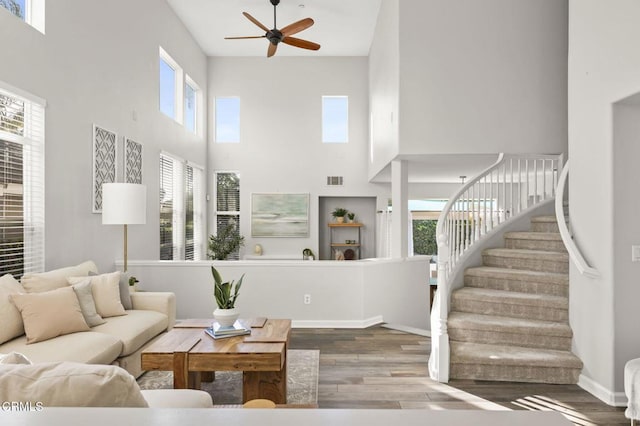 living room featuring wood-type flooring and ceiling fan