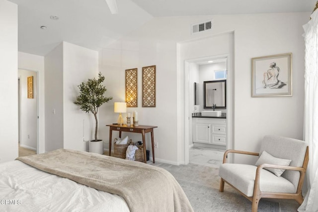 carpeted bedroom featuring vaulted ceiling, connected bathroom, and sink